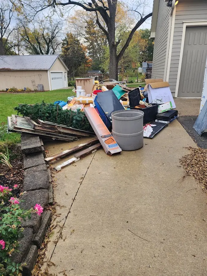 Dumpster being loaded with debris for Residential Dumpster Rental in St. Ann